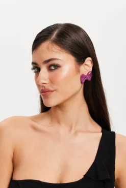 Liquorish Diamonte Bow Stud Earrings In Pink