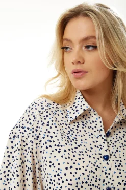 Women's Heart Print Shirt in Cream - Navy hearts, button-up front, heart-shaped buttons, collar, long sleeves, regular fit.