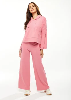 Women's Oversized Hooded Sweatshirt with Front Pocket in Pink - Stylish, Comfortable, with Side Slits and Adjustable Hood