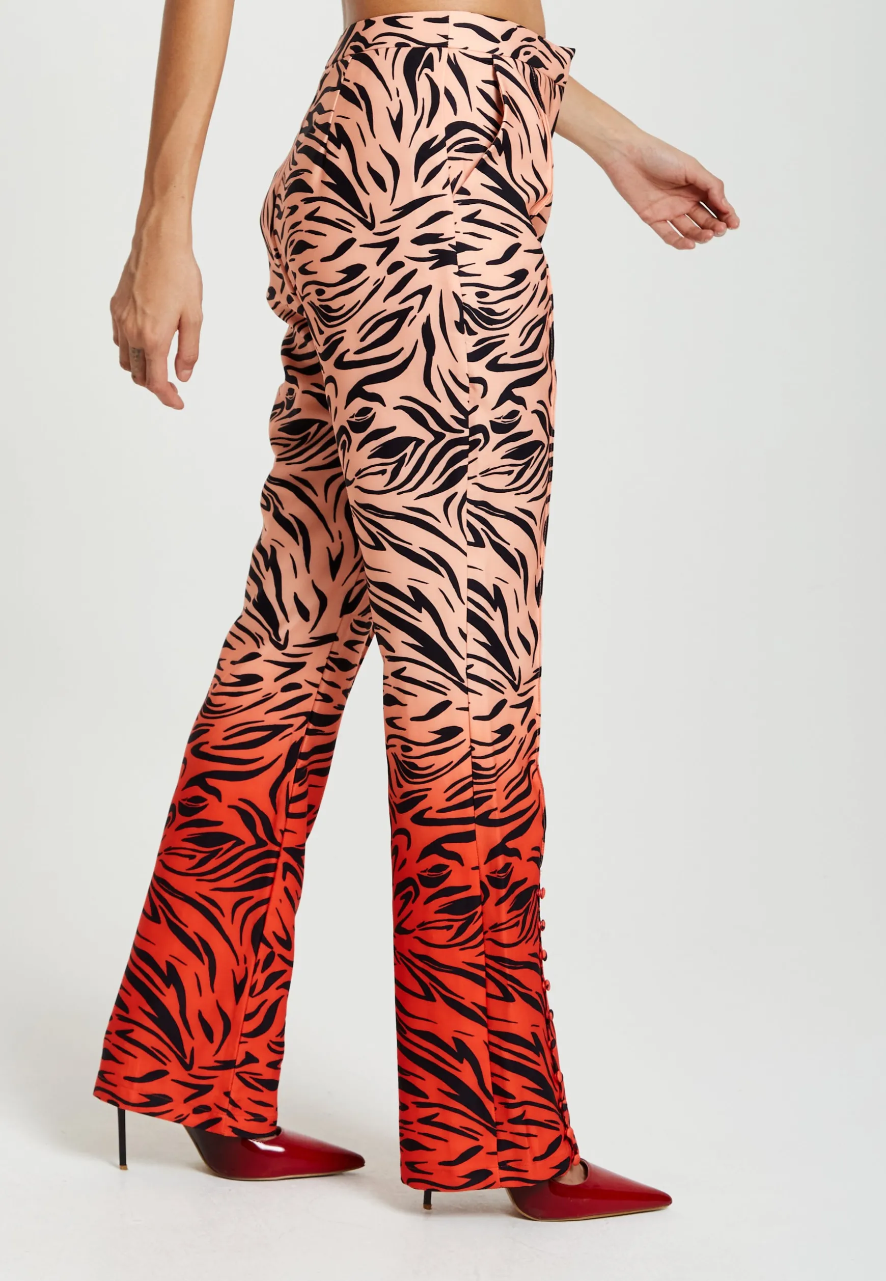 Women's Trousers in Orange and Nude Zebra Print with Slit Detail and Button Closure by Liquorish