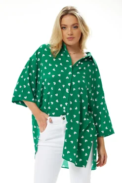 Women's White Heart Print Shirt in Green - Short sleeves, oversized fit, heart-shaped buttons, button-up front, collar.